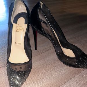 Beautiful Christian Louboutin pumps with gold stones on them